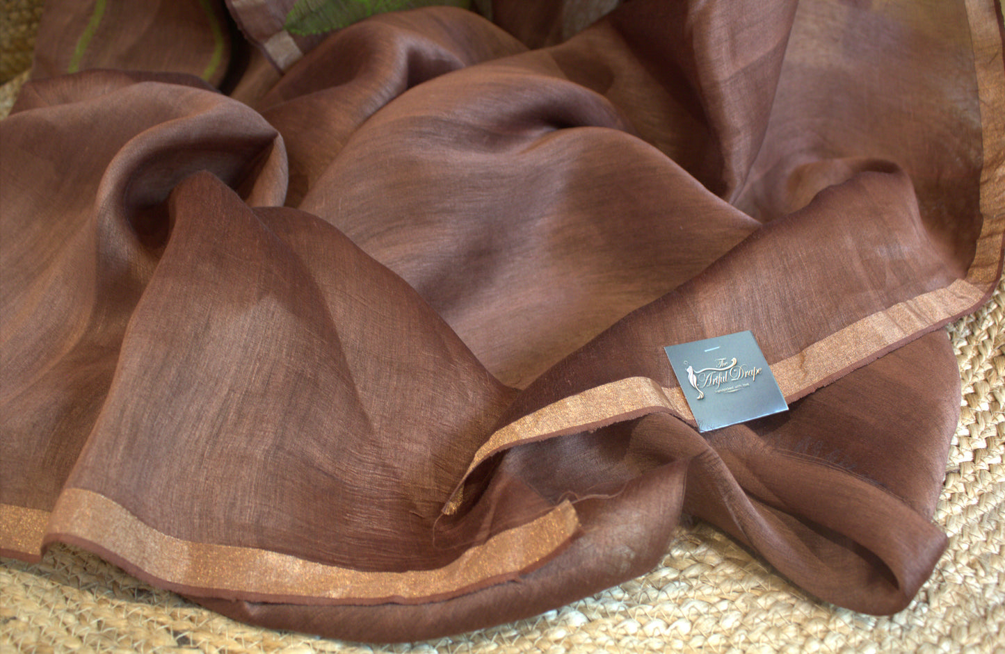 Silk linen onion color saree with lotus weaving and running plain blouse with zari